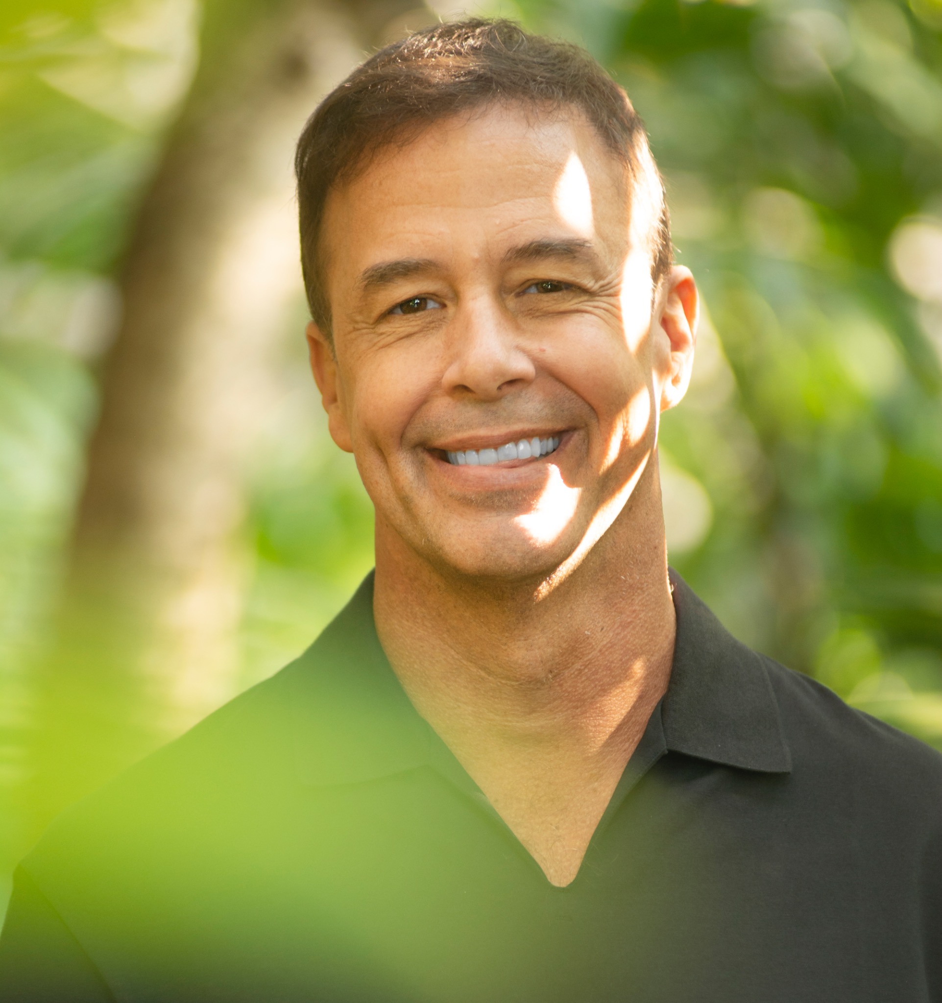 Troy McFadden Outdoors Among Green Foliage